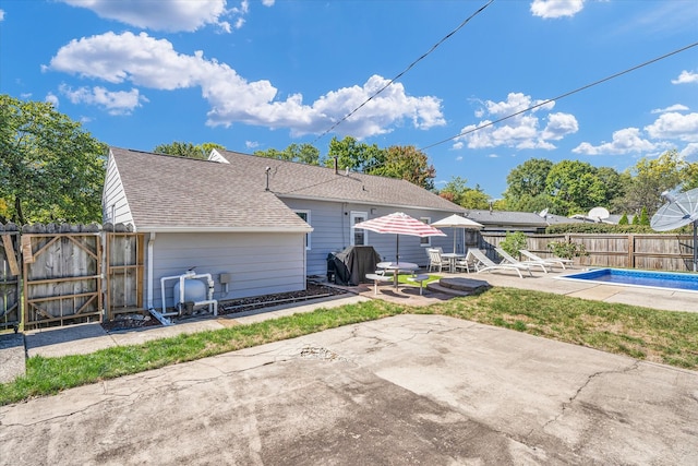 back of house with a patio and a fenced in pool