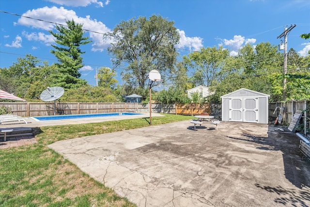 view of patio / terrace with a fenced in pool and a storage unit