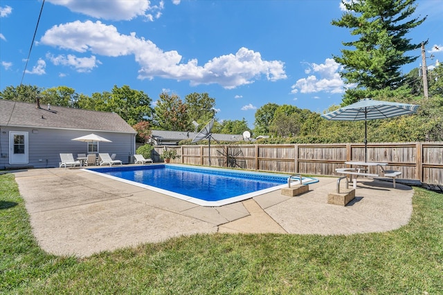 view of pool with a yard and a patio area