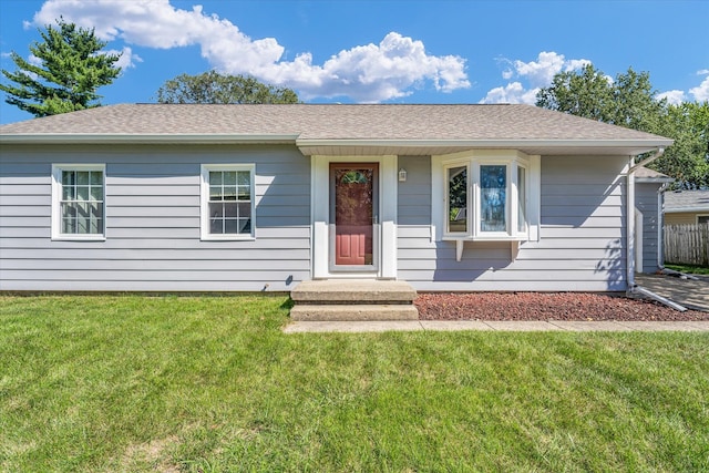 ranch-style home with a front lawn