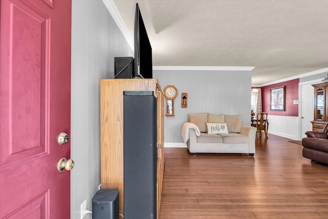 living room featuring crown molding, a textured ceiling, and dark hardwood / wood-style floors