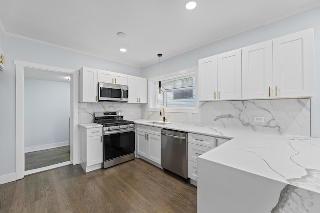 kitchen featuring light stone countertops, white cabinetry, dark wood-type flooring, stainless steel appliances, and decorative light fixtures