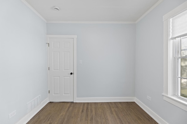 empty room with dark hardwood / wood-style floors and ornamental molding