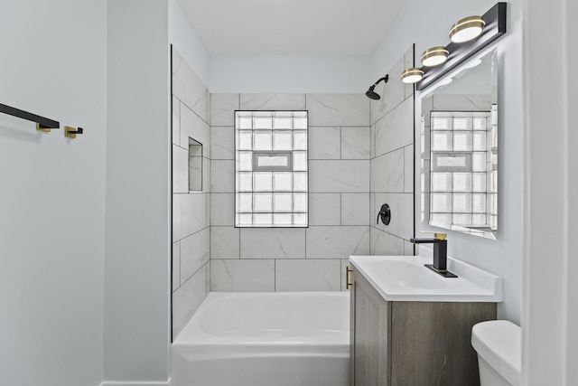 full bathroom with vanity, toilet, and tiled shower / bath