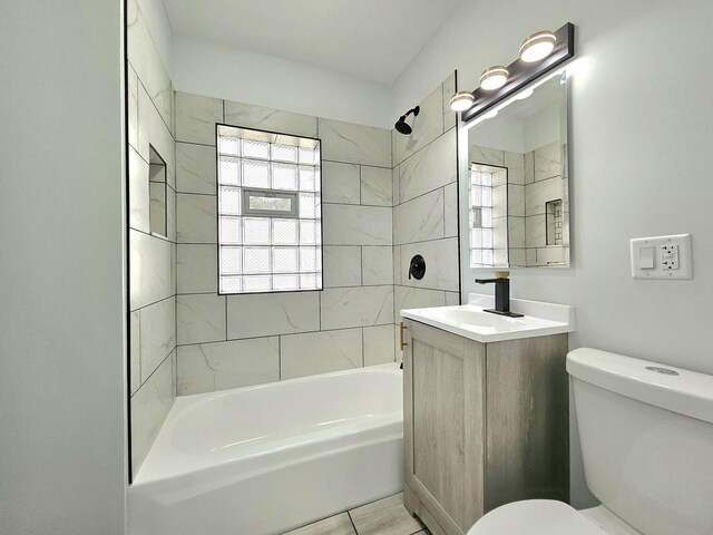 full bathroom featuring vanity, toilet, and tiled shower / bath