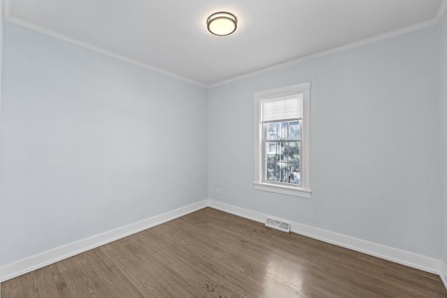 unfurnished room with hardwood / wood-style floors and ornamental molding