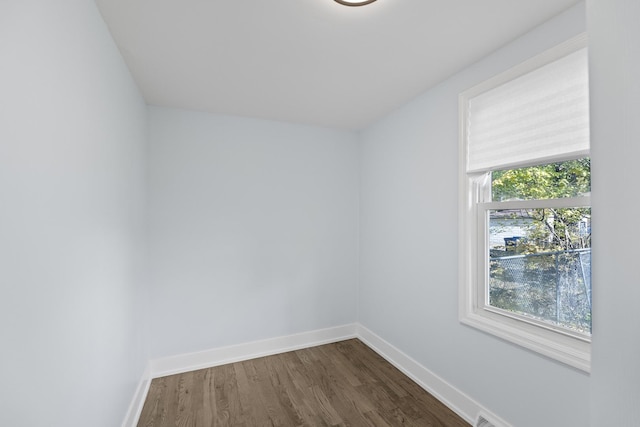 unfurnished room featuring dark hardwood / wood-style floors