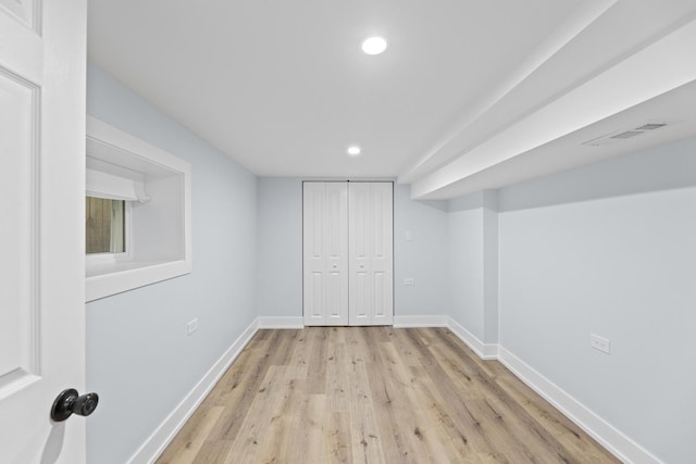 basement with light hardwood / wood-style floors