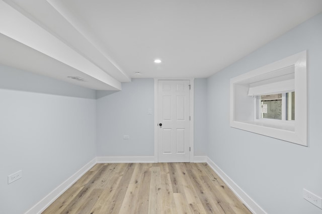 basement with light hardwood / wood-style flooring