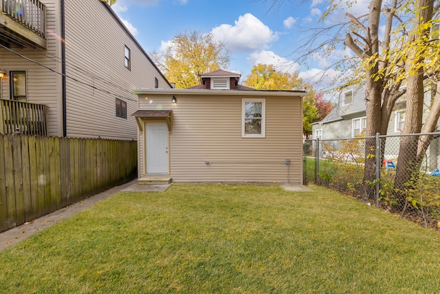 rear view of house with a lawn