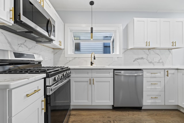 kitchen featuring sink, hanging light fixtures, stainless steel appliances, dark hardwood / wood-style floors, and white cabinets