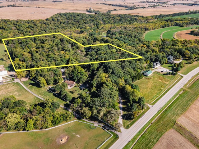 drone / aerial view featuring a wooded view