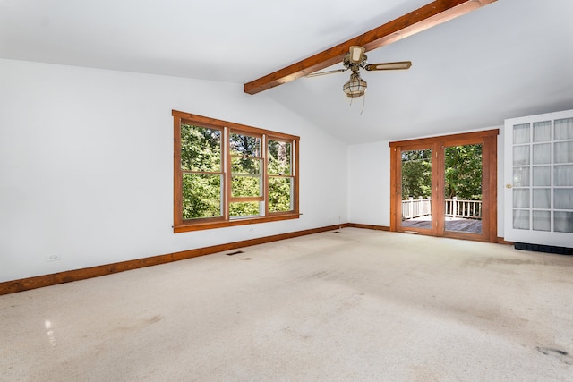 carpeted spare room featuring vaulted ceiling with beams, ceiling fan, and a wealth of natural light