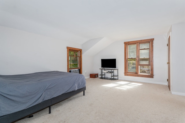 carpeted bedroom with lofted ceiling