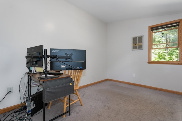 carpeted home office with lofted ceiling