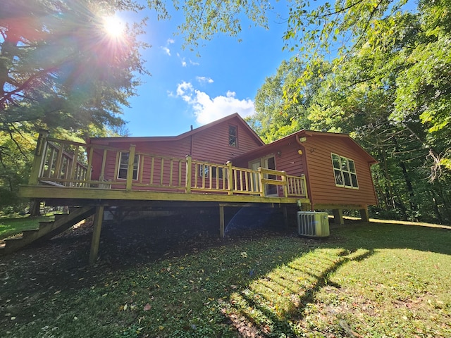 rear view of property with a wooden deck, a yard, and cooling unit