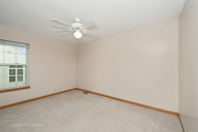 empty room with light carpet and ceiling fan