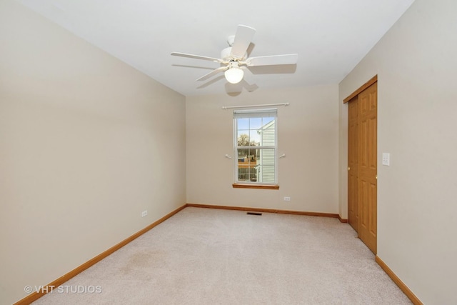 carpeted empty room with ceiling fan