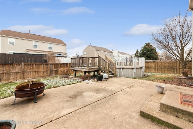 view of patio / terrace with a wooden deck and a fire pit