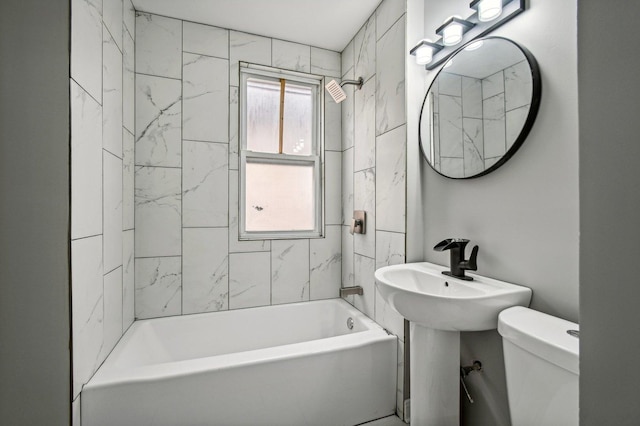 full bathroom with toilet, tiled shower / bath, and sink