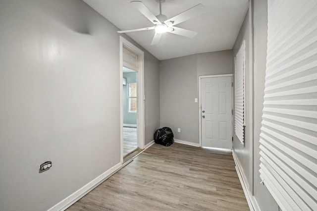 foyer entrance with ceiling fan and light hardwood / wood-style floors