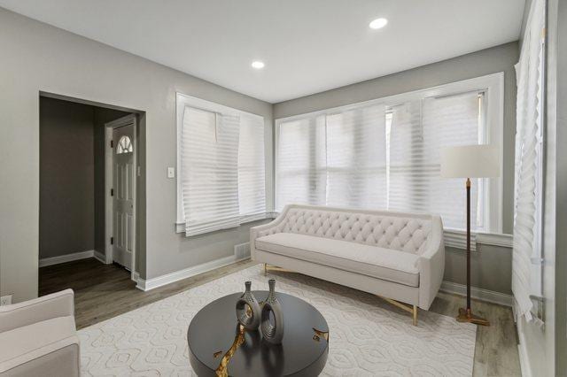 sitting room with wood-type flooring