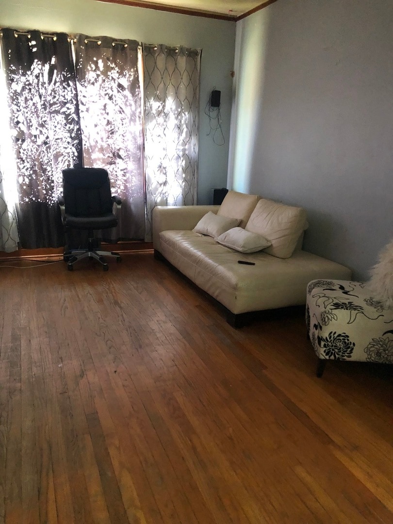 living area with hardwood / wood-style floors