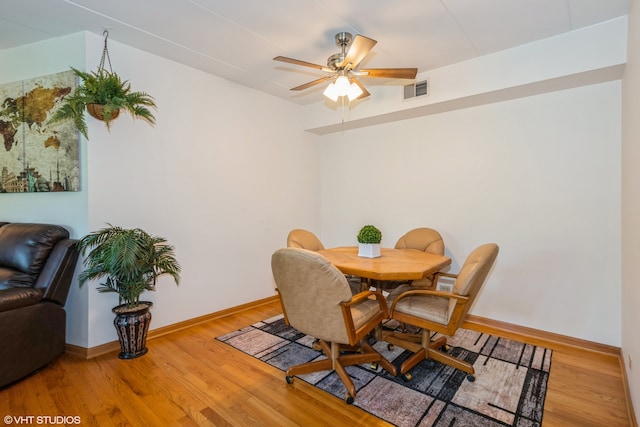 dining room featuring wood-type flooring and ceiling fan