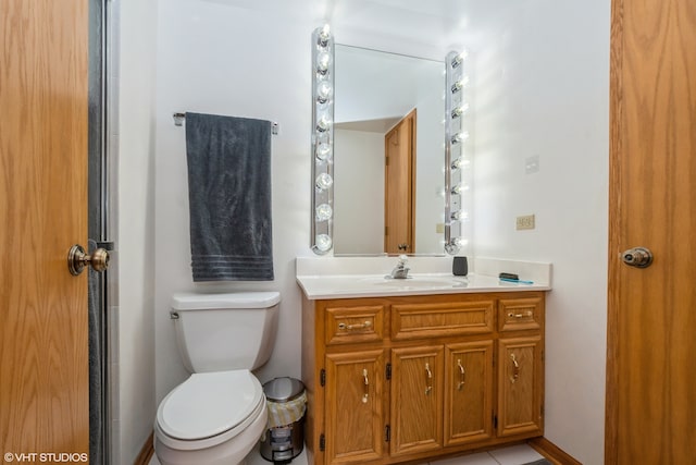 bathroom with tile patterned flooring, vanity, and toilet