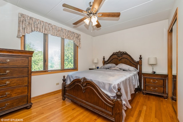 bedroom featuring light wood-type flooring, ceiling fan, and a closet