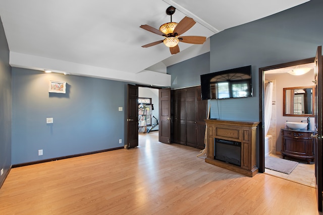 unfurnished living room featuring ceiling fan, light hardwood / wood-style flooring, and high vaulted ceiling