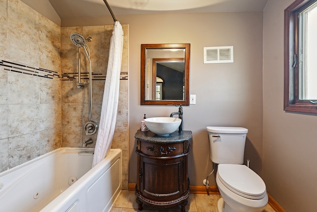 full bathroom with shower / bath combo with shower curtain, tile patterned floors, vanity, and toilet