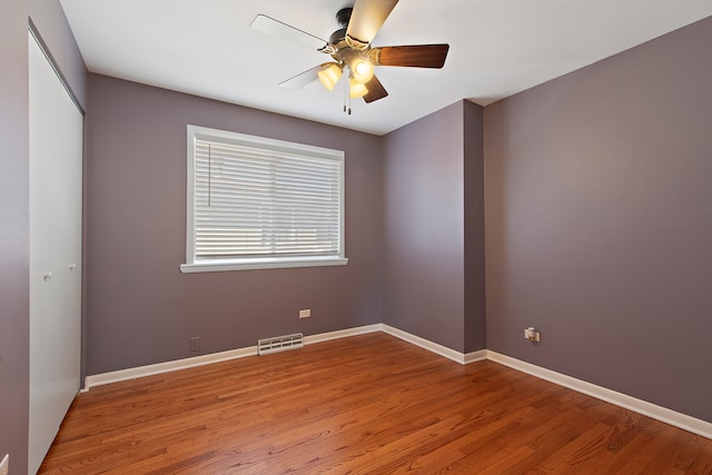 empty room with ceiling fan and light wood-type flooring