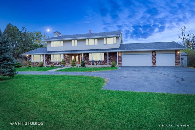 view of front of home featuring a front lawn, a garage, and covered porch