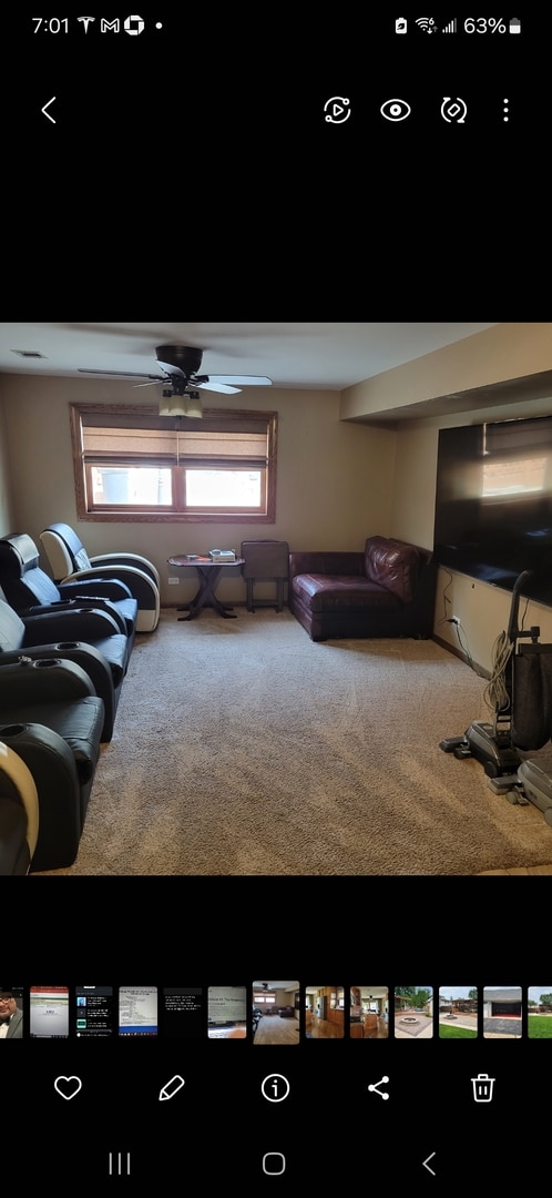 living room featuring carpet floors and ceiling fan