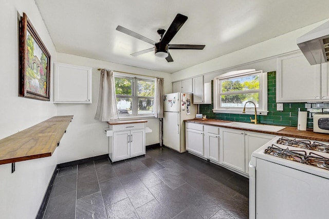 kitchen with white cabinets, white appliances, and butcher block counters