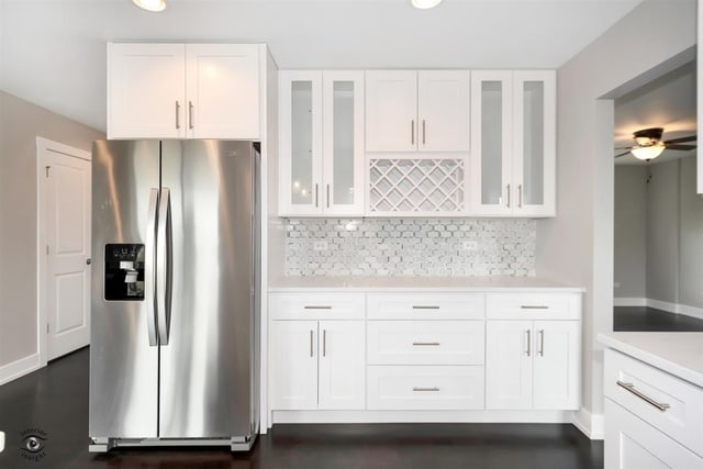 kitchen featuring ceiling fan, stainless steel fridge with ice dispenser, and white cabinets