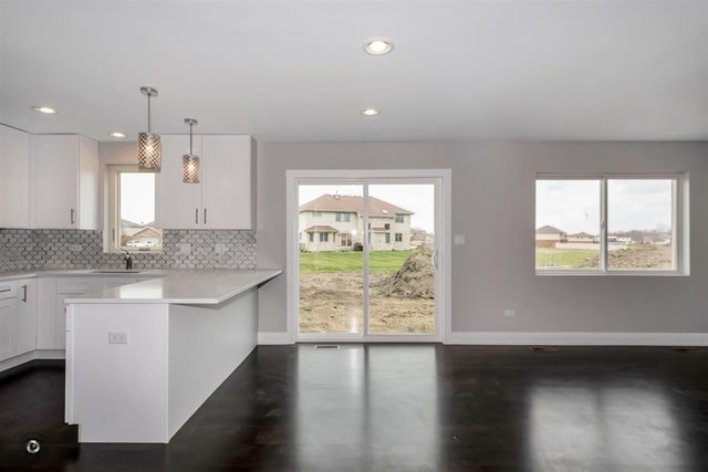 kitchen with pendant lighting, plenty of natural light, and white cabinetry