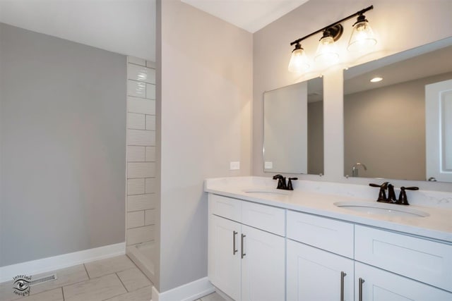 bathroom with a shower and vanity