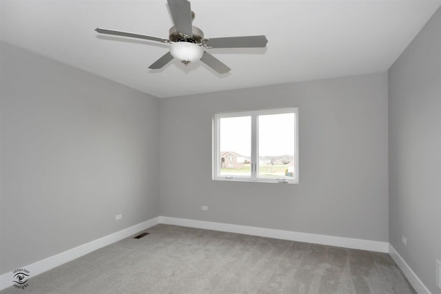 unfurnished room featuring ceiling fan and light colored carpet