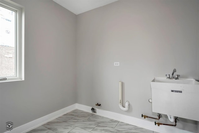 laundry area featuring hookup for a gas dryer, a healthy amount of sunlight, and sink