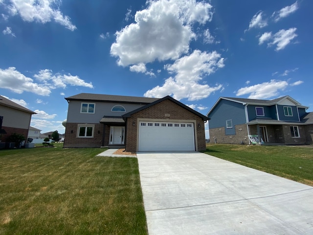 view of front of home featuring a front yard and a garage