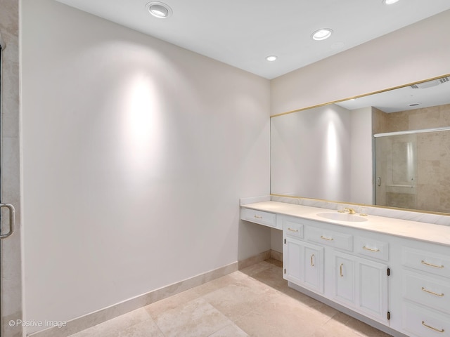 bathroom featuring tile patterned flooring, vanity, and a shower with shower door