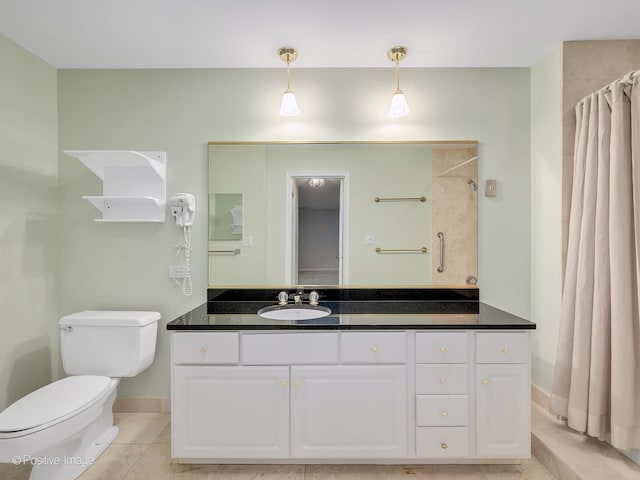 bathroom with a shower with curtain, vanity, toilet, and tile patterned floors