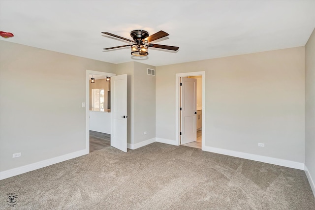 carpeted empty room featuring ceiling fan