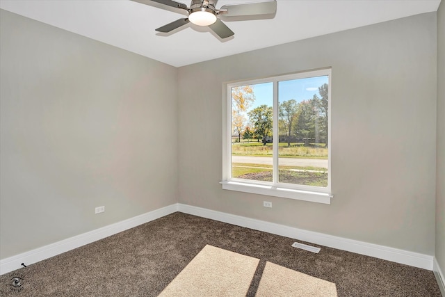 carpeted spare room with ceiling fan