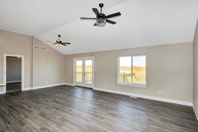 unfurnished room featuring a wealth of natural light, lofted ceiling, dark hardwood / wood-style floors, and ceiling fan