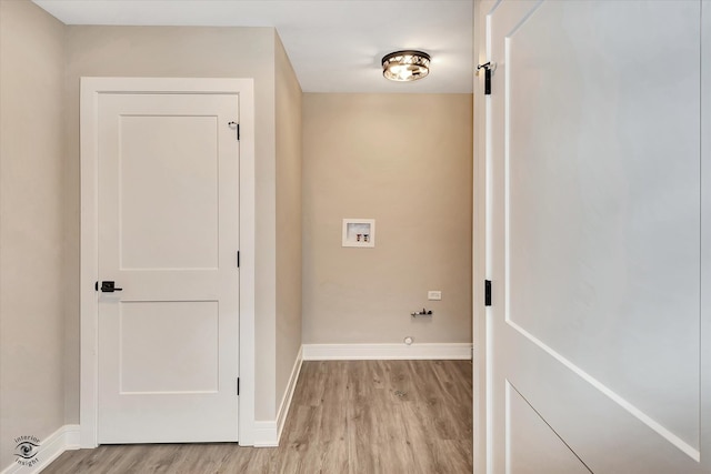 washroom featuring light hardwood / wood-style floors, hookup for a washing machine, and hookup for a gas dryer