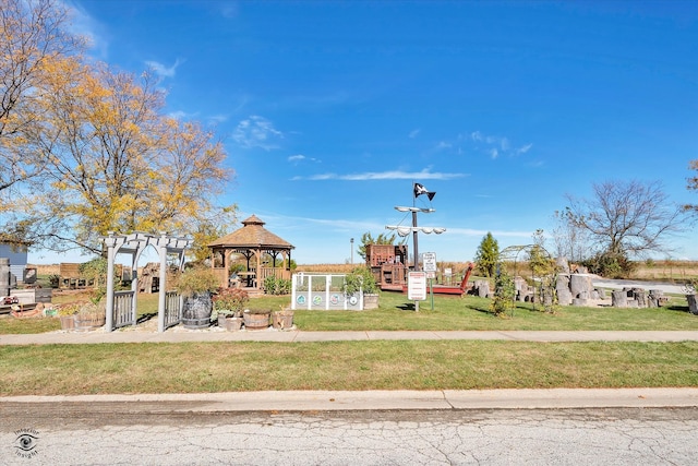 view of playground with a gazebo and a lawn