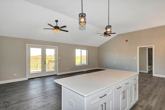 kitchen with a center island, dark hardwood / wood-style flooring, white cabinetry, ceiling fan, and vaulted ceiling